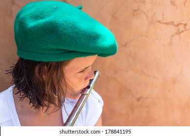 Girl Hat Music Mouth Organ Teen Girl Unidentified Wearing Green Beret Hat Plays Practices With Wind Flute Instrument.