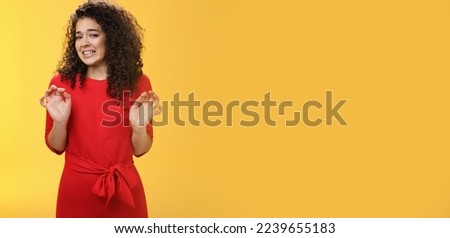 Girl hates washing dished grimacing from dislike and disgust wanting puke from aversion raising palms and stepping back frowning refusing displeasing offer over yellow background. Copy space