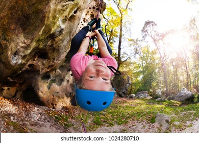 Girl having fun during rock climbing training