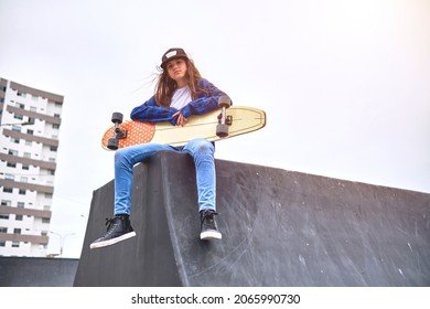 Girl having fun riding skateboards at skate park, Portrait of smiling young female skateboarder holding her skateboard. Recreational Activity Concept. - Powered by Shutterstock