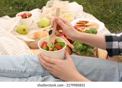 Girl Having Picnic On Green Grass In Park, Closeup