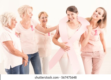 Girl having women's support in breast cancer fight - Shutterstock ID 567475648
