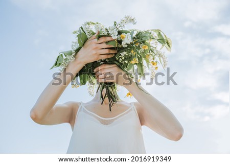 Similar – Woman making wild flowers at home in vase