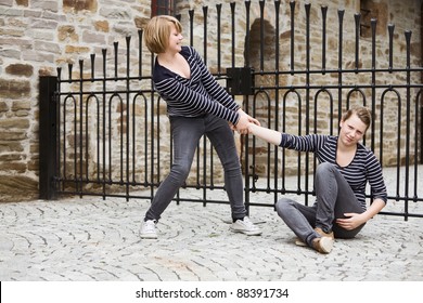 Girl Helping Her Sister To Get Up