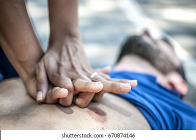 Girl Helping An Unconscious Guy With Cpr And Cardiac Massage