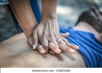 Girl Helping An Unconscious Guy With Cpr And Cardiac Massage