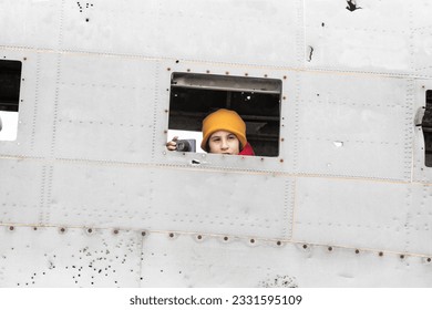 Girl with her camera in the window of the plane that crashed on a beach in Iceland