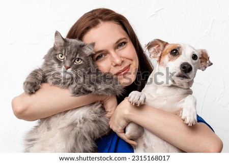 A girl with her cat and dog