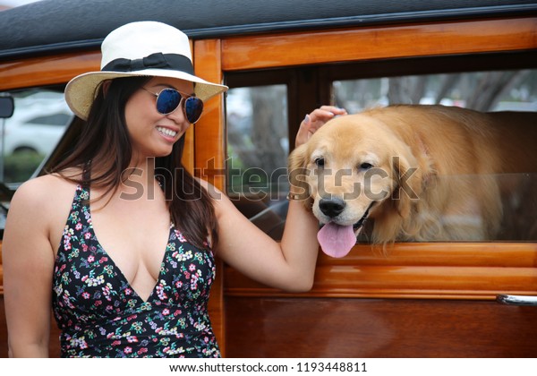 Girl\
with her dog. A beautiful woman with classic car and  beautiful\
dog. classic car. beautiful woman. beautiful\
dog.\
