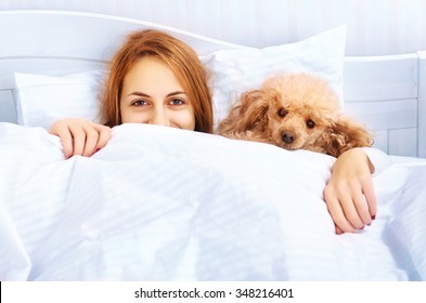 Girl And Her Dog In The Bed