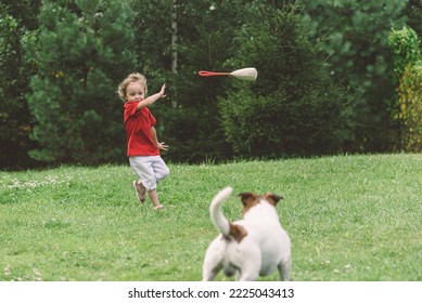 Girl And Her Dog Playing Outside On Green Grass Lawn In Backyard