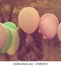 Girl Hiding Behind The Balloon