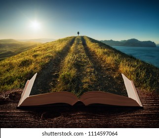 Girl hiker with backpack and trekking sticks standing on a mountain top against sunset on the pages of an open magical book. Majestic landscape. Travel concept.