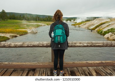 Girl Hiker on Bridge Over River in Yellowstone National Park