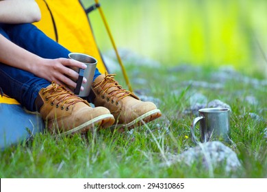 girl hiker in a tent and holding a cup  - Powered by Shutterstock