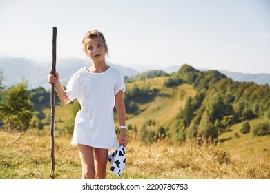 Girl Is Hiking In The Carpathian Mountains In Ukraine. Holding Wooden Stick In Hand.