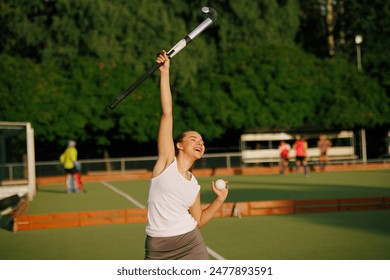 girl hockey player plays field hockey on a sunny day, female hockey player celebrates a goal scored, victory in a field hockey match, active sport for girls - Powered by Shutterstock