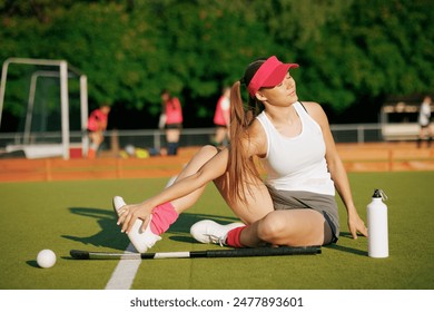 girl hockey player plays field hockey on a sunny day, a hockey player was injured in a game of field hockey, sports injuries - Powered by Shutterstock