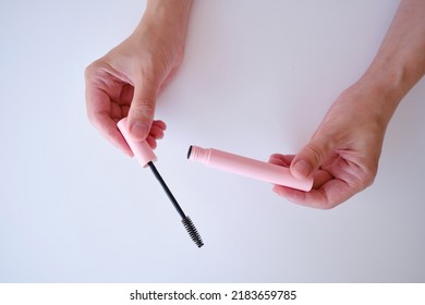 Girl hold mascara. Eyelash brush. Pink tube of mascara. Makeup cosmetics - Powered by Shutterstock