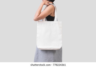 Girl is holding bag canvas fabric for mockup blank template isolated on gray background.  - Shutterstock ID 778224361