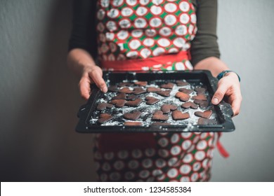 Girl Holding Baking Tray With Burnt Gingerbread Cookies