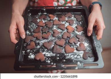 Girl Holding Baking Tray With Burnt Gingerbread Cookies