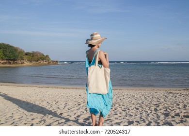 Girl Is Holding Blank Canvas Tote Bag On Beach, Woman Travelling Back View