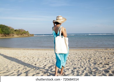 Girl Is Holding Blank Canvas Tote Bag On Beach, Woman Travelling Back View