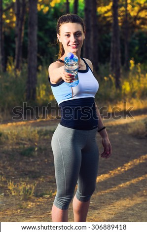 Similar – Woman in sports wear with earphones looking smartphone