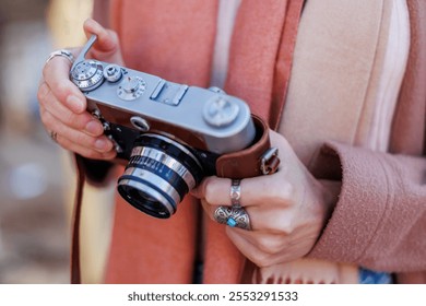 girl holding camera while walking. fashion and style. hipster girl takes pictures with a film camera. lifestyle concept, focus on camera. - Powered by Shutterstock