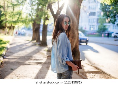 Girl Is Holding A Clutch Bag.