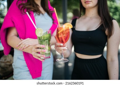 Girl Holding Cocktails In Her Hands Girl Holding Aperol And Mojito In Her Hands. Summer Time. Heat.