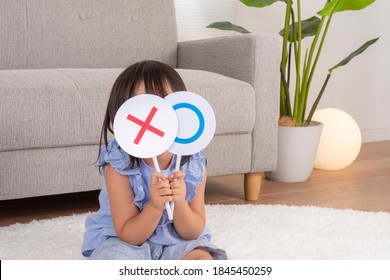 Girl Holding A Correct Answer Panel In Her Hand