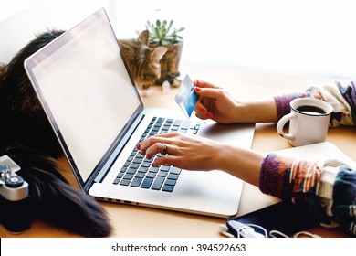 girl holding credit card and typing on laptop, shop online home concept