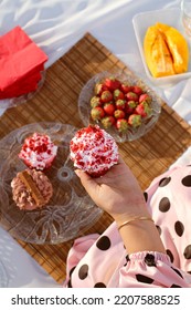 Girl Holding Cupcake On Picnic