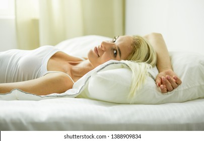 Girl holding digital tablet with blank screen and smiling at camera in bedroom - Shutterstock ID 1388909834