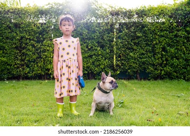 Girl Holding Dog Leash At Park Against Sun Light.