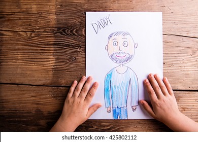 Girl holding drawing her