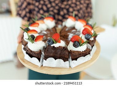 Girl Holding Fresh Baked Brownies In Tray For Selling In Home Cafe. Selective Focus.