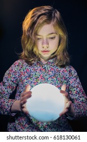 Girl Holding A Glowing Orb