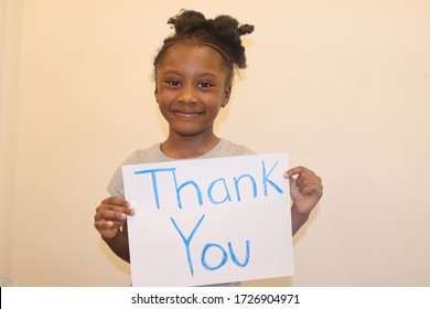 Girl Holding Homemade Thank You Sign