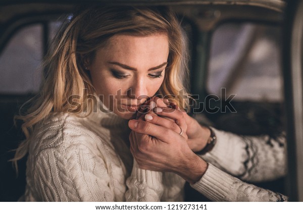 Girl\
holding man\'s hands in vintage car in\
Christmas