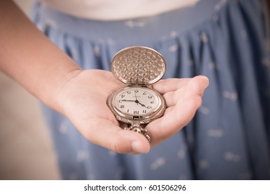 girl holding old Fashioned Pocket Watch - Shutterstock ID 601506296