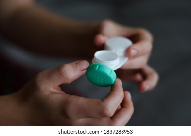 Girl Holding And Opening The Contact Lense Case