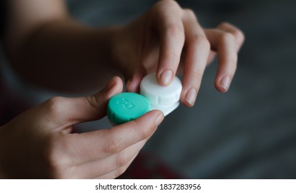 Girl Holding And Opening The Contact Lense Case