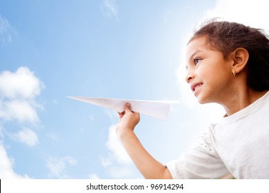 Girl Holding A Paper Airplane And Dreaming Aboyt Flying