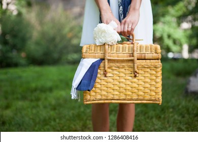 A Girl Holding A Picnic Basket And Peony Flower In Central Park. Ready For Brunch Or Lunch. 