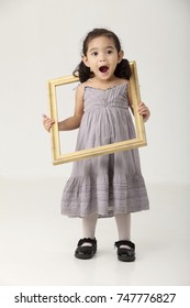 Girl Holding Picture Frame