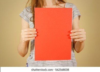 Girl Holding Red A4 Blank Paper Vertically. Leaflet Presentation. Pamphlet Hold Hands. Woman Show Clear Offset Paper. Sheet Template. Booklet Design Sheet Display Read First Person.