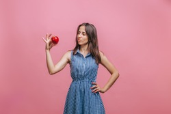 Girl Holding Red Apple On Pink Background